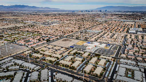 A large, sprawling residential area with a mountain range in the distance.
