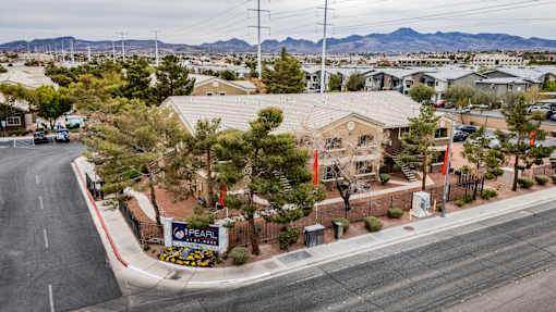 A street view of a residential area with a sign that reads "Pearl".