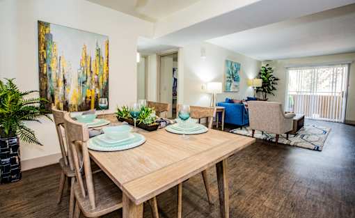 A dining room with a wooden table and chairs.