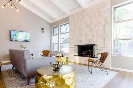 a living room with a fireplace and a couch and a table