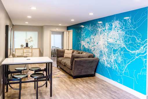 a lounge room with a blue wall with a couch and a table