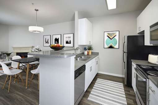 an open kitchen with a large island and a dining table