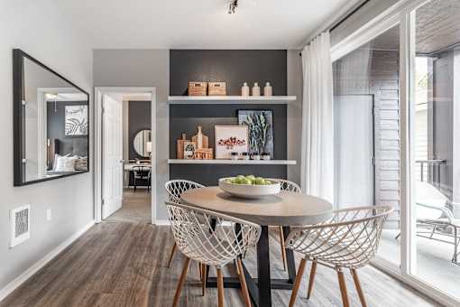 a dining room with a table and chairs and a window