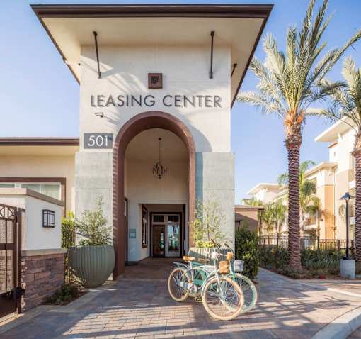 A leasing center with bicycles parked in front.