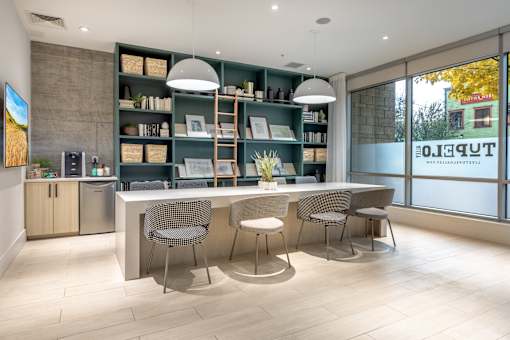 A modern kitchen with a dining table and chairs.