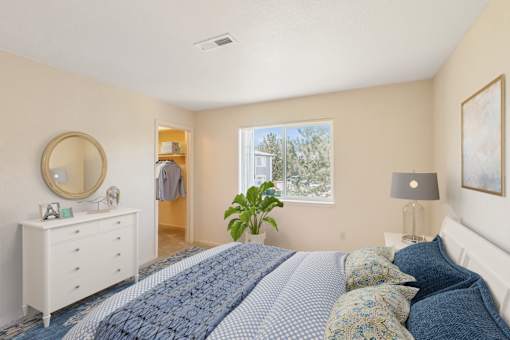 a bedroom with a bed and a dresser and a window