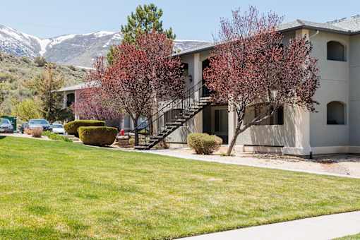 an apartment building with mountains in the background