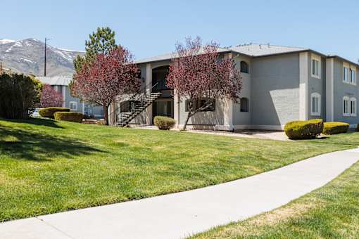 a gray house with a sidewalk in front of it