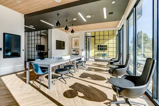 coworking space with a long table and chairs and large windows