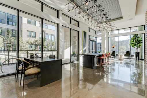 a large room with large windows and a table and chairs