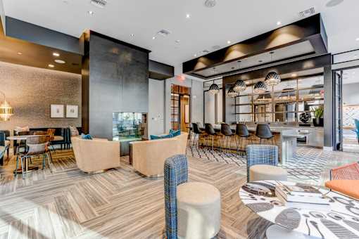 a lounge area with tables and chairs and a fireplace