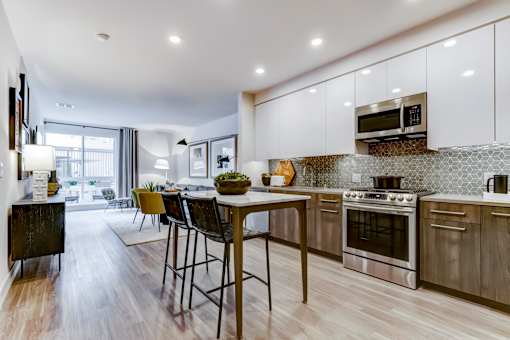 an open kitchen and living room with a table and chairs