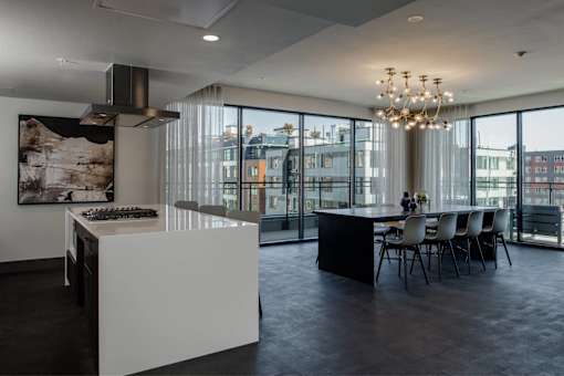 a kitchen and dining area with a large window and a table with chairs