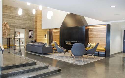 a living room with a fireplace and a table and chairs