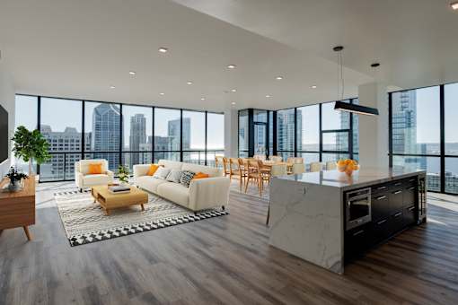 a living room with a kitchen and a city view
