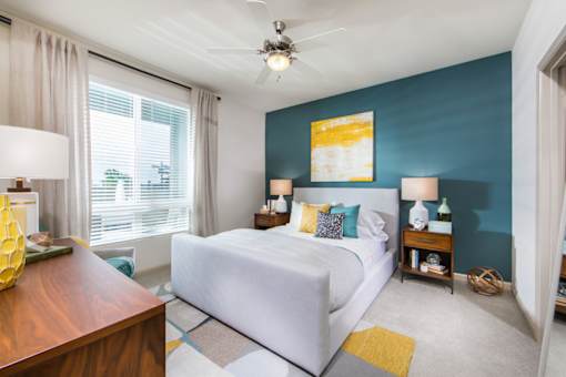 bedroom with white bed and large window