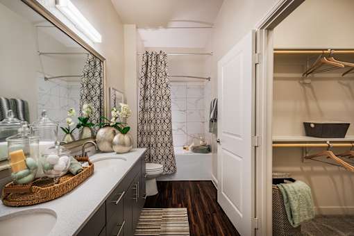 A bathroom with a white sink and a mirror.