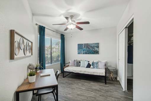 a living room with a ceiling fan and a couch