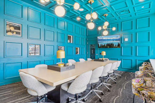 a conference room with blue walls and a long table with chairs