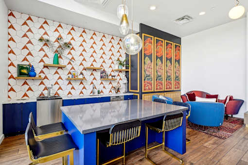 a dining room with a blue table and chairs