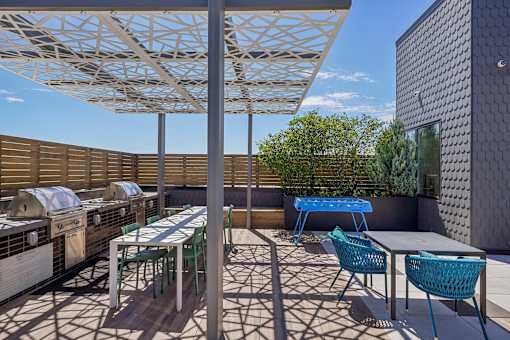 a patio with tables and chairs and a pergola