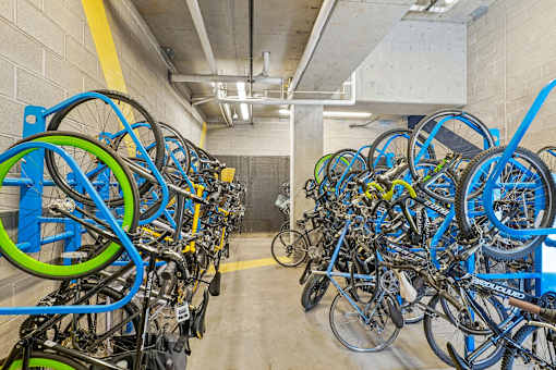 a room filled with lots of blue and green bikes