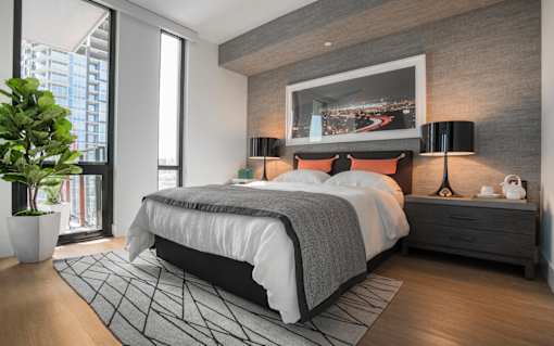 a bedroom with a bed and a painting on the wall