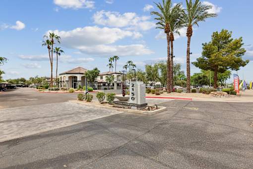 A parking lot with palm trees and a sign that says "Parking".