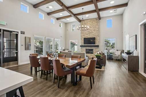 A dining room with a long table and chairs.