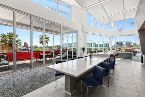 A large conference room with a long table and chairs.