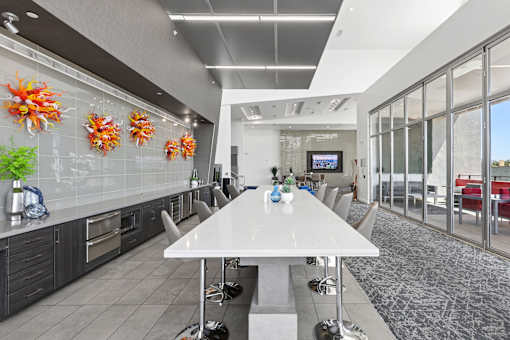 A modern kitchen with a dining table and chairs.