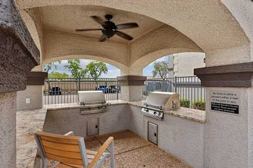 A patio with a fan and a sign that says no food or drinks are allowed within 4 feet of the pool or spa.