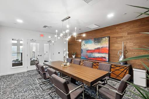 A conference room with a long table and chairs.