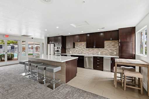 A kitchen with a bar area and a dining table.