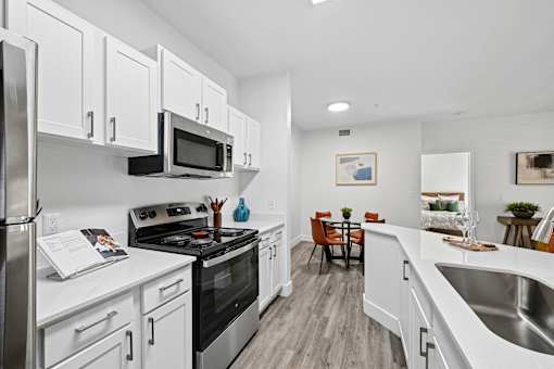 A kitchen with white cabinets and stainless steel appliances.