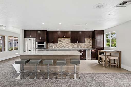 A modern kitchen with a bar area and a dining table.