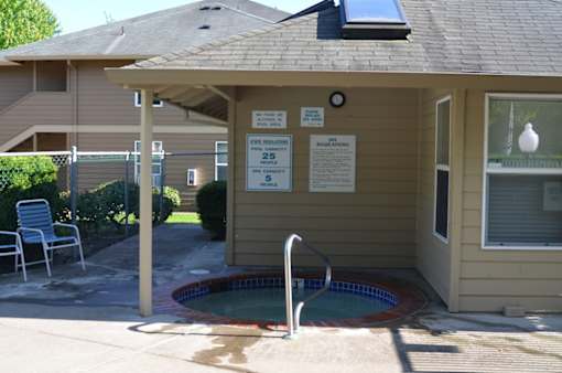 A pool with a sign that says pool regulations.