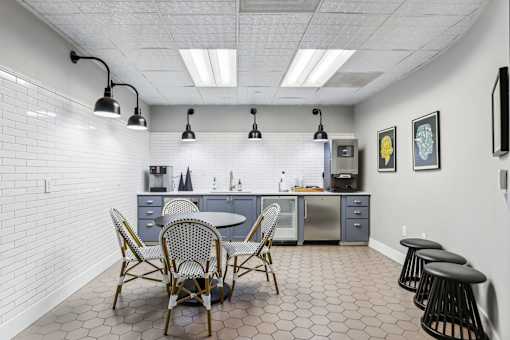 a dining room with a table and chairs and a kitchen