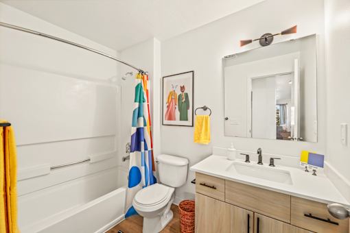 A bathroom with a toilet, sink, and shower.