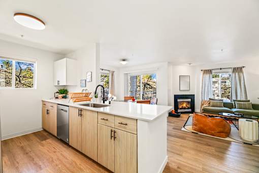 A modern kitchen with wooden cabinets and a white countertop.