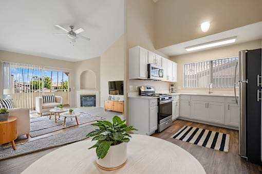 an open living room with a kitchen and a living room