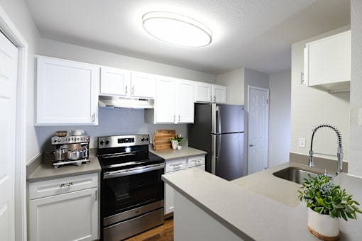 a kitchen with stainless steel appliances and white cabinets