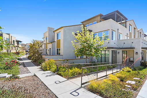 A modern house with a garden in front.