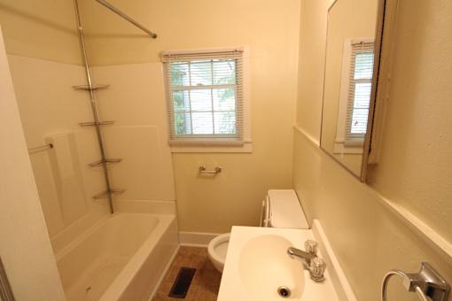 a small bathroom with a sink toilet and shower