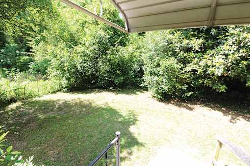a backyard with a fence and some trees