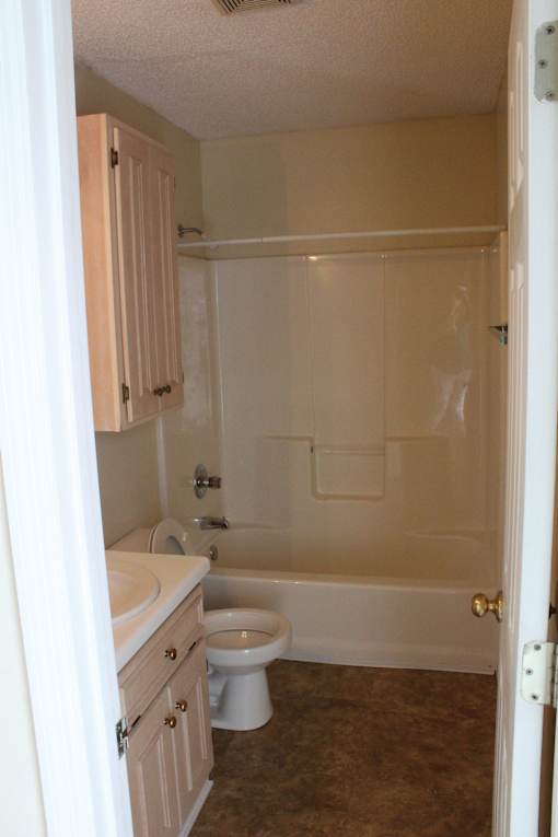 a bathroom with a toilet and a sink and a bath tub
