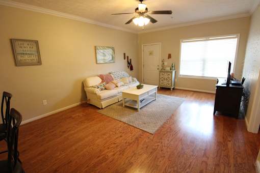 an empty living room with a couch and a table