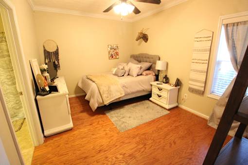 a bedroom with a bed and a ceiling fan