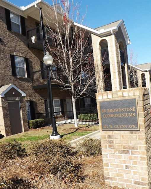 an apartment building with a sign in front of it