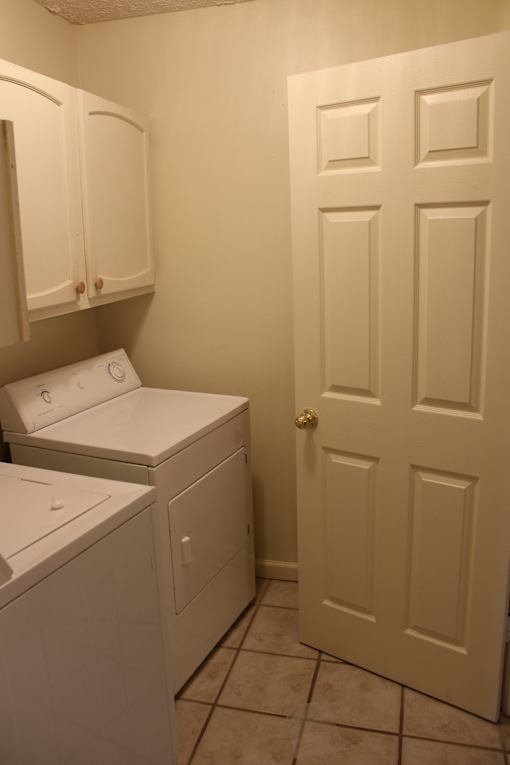 a laundry room with a washer and dryer and a door